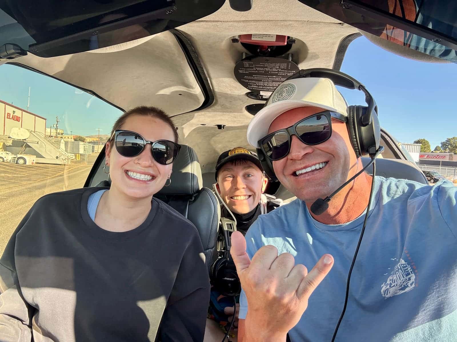 Volunteer pilot and passengers smiling in the cockpit after an Angel Flight West mission