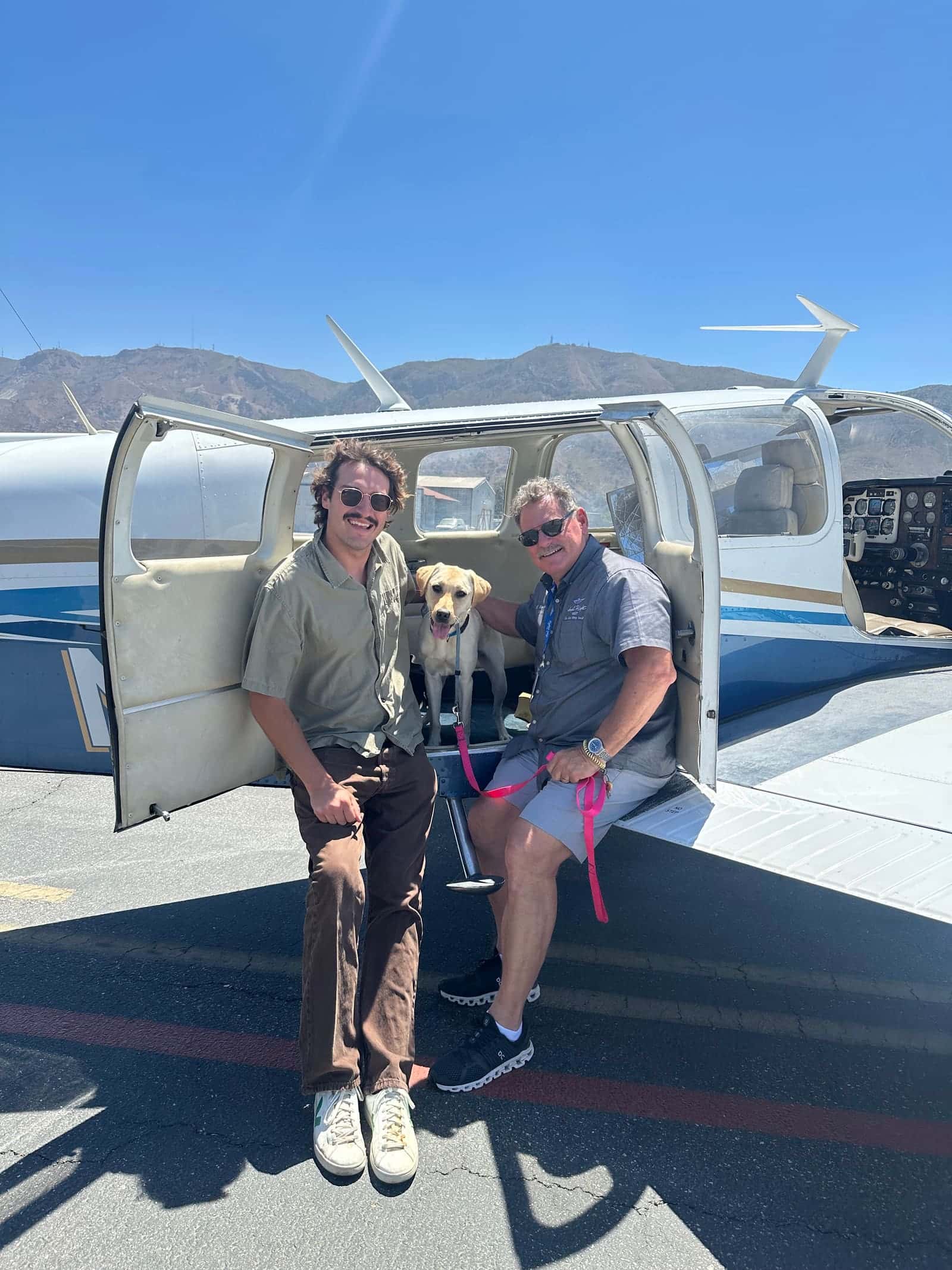 Volunteer pilots with a service dog boarding a general aviation aircraft
